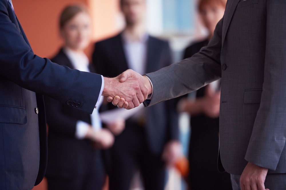 two businessman handshake.jpeg